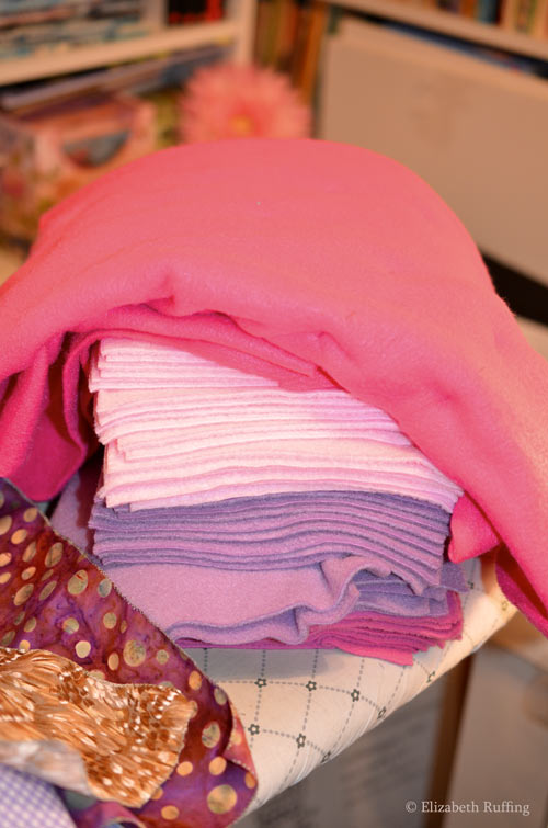 Pile of pink and lavender fleece cut out, waiting to be sewn into toys, Elizabeth Ruffing
