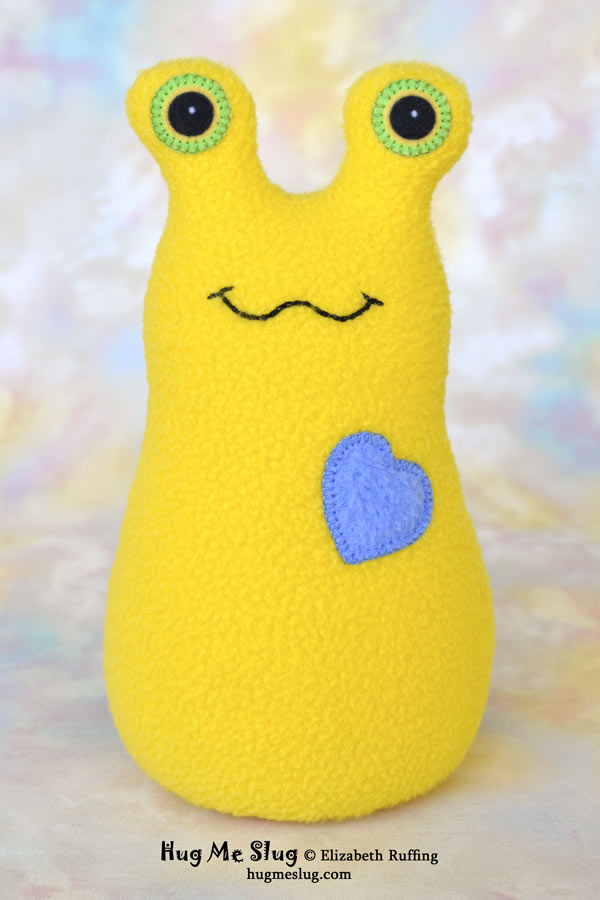 Lemon yellow Hug Me Slug plush toy by Elizabeth Ruffing
