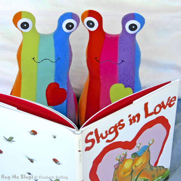 12 inch Handmade Rainbow Striped Hug Me Slug Stuffed Animal Plush Art Toys by artist Elizabeth Ruffing, reading Slugs in Love book