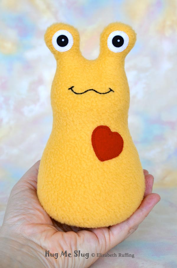 Hug Me Slug Stuffed Banana Slug Plush Toy Art, Golden Yellow Fleece, Red Heart, Personalized Tag, 7 inch, by artist Elizabeth Ruffing, Ruffing's