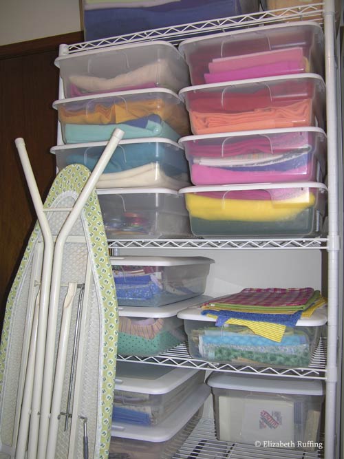 Sewing supply shelf with fabric in boxes