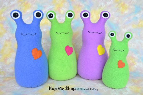 Blue, green, and orchid fleece Hug Me Slugs by Elizabeth Ruffing