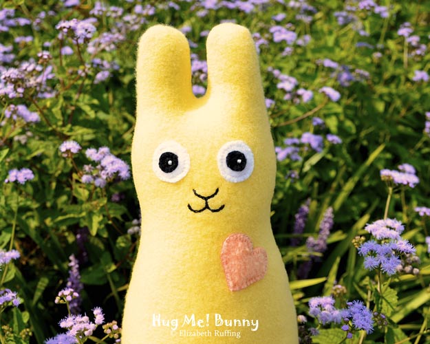Soft yellow fleece Hug Me Bunny Rabbit by Elizabeth Ruffing, with lavender ageratum