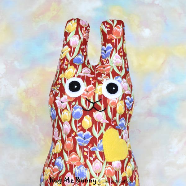 Red, orange, yellow, blue tulip print Hug Me Bunny rabbit art toy by Elizabeth Ruffing
