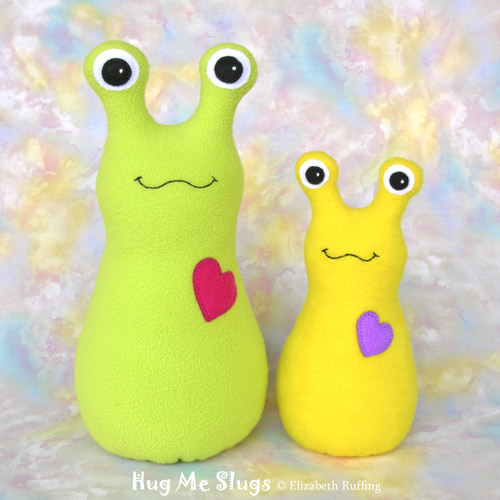 Bright light green and bright yellow Hug Me Slugs, original art toys by Elizabeth Ruffing