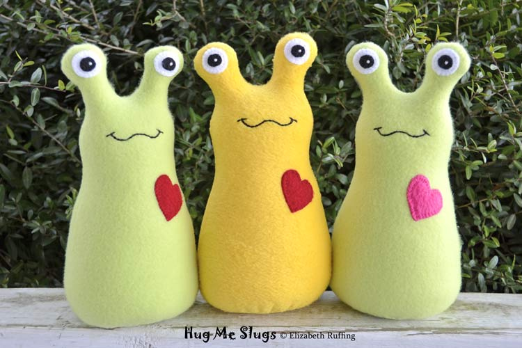 Light green and daffodil yellow Hug Me Slugs, original art toys by Elizabeth Ruffing