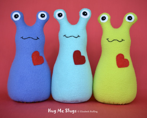 Cobalt blue, Light Turquoise, and Bright Light Green Hug Me Slugs, original art toys by Elizabeth Ruffing