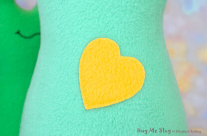 Yellow fleece heart on aqua stuffed animal slug