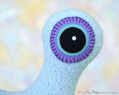 Hug Me Slug, Light Blue , Purple Heart, 12 inch, handmade stuffed animal banana slug art toys by artist Elizabeth Ruffing, eye detail