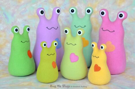 Assorted fleece Hug Me Slug plush toys by artist Elizabeth Ruffing