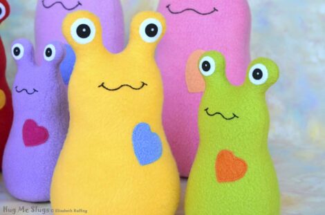 Assorted fleece Hug Me Slug plush toys by Elizabeth Ruffing