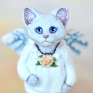 White cat angel with blue eyes and peach rose at neck