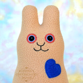Smiling camel fleece bunny with a royal blue heart