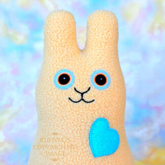 Smiling light camel fleece bunny with a light turquoise heart
