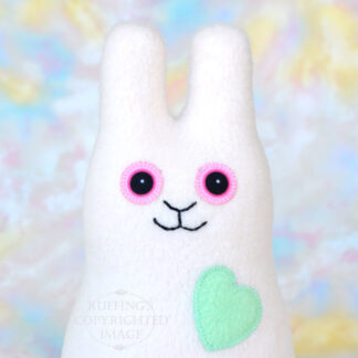 Smiling vanilla colored fleece bunny with a mint green heart