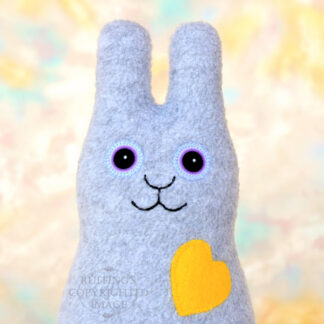 Smiling heather gray bunny with a yellow heart