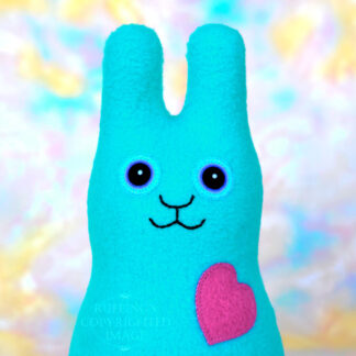 Smiling turquoise blue fleece bunny with a magenta pink heart.
