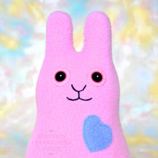 Smiling lavender-pink fleece bunny with a cornflower blue heart