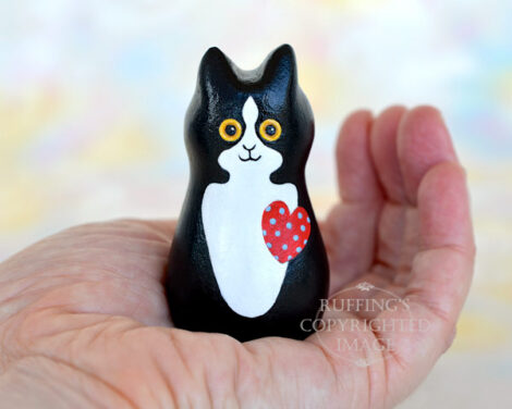 Black-and-white-tuxedo kitten with a red heart with blue polka dots