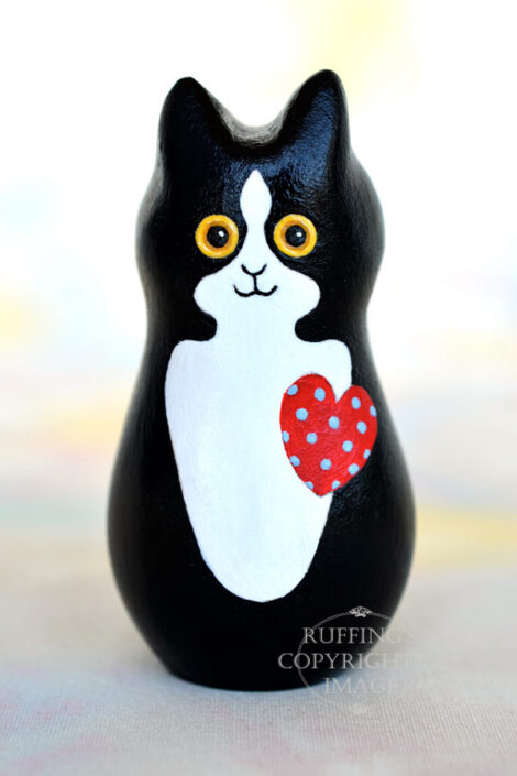 Black-and-white-tuxedo kitten with a red heart with blue polka dots