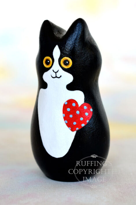 Black-and-white-tuxedo kitten with a red heart with blue polka dots
