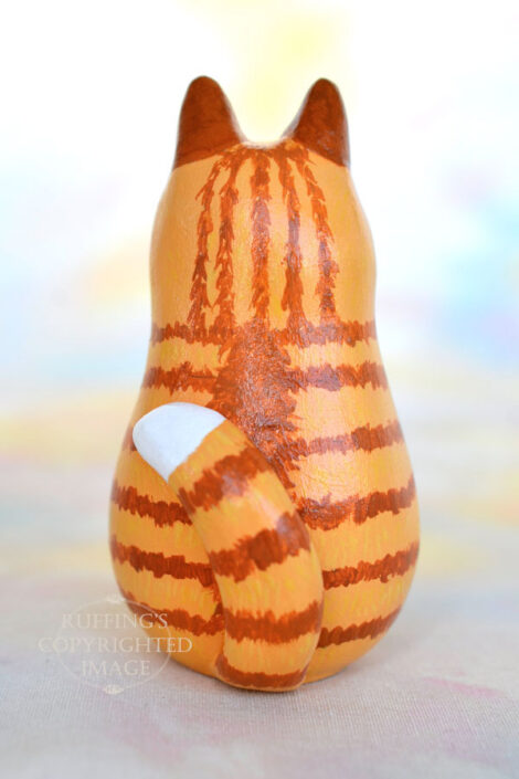 Ginger-and white-tabby cat figurine back view with a white tipped tail
