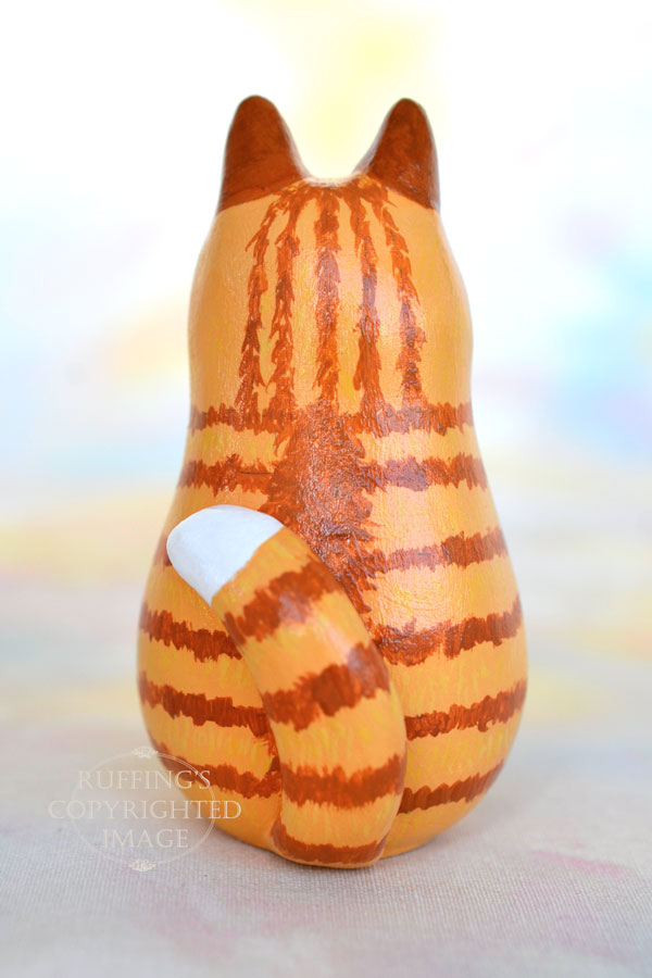 Ginger-and white-tabby cat figurine back view with a white tipped tail